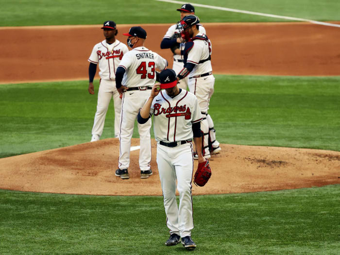 Oct 14, 2020; Arlington, Texas, USA; Atlanta Braves starting pitcher Kyle Wright (30) reacts after being removed from the game by manager Brian Snitker (43) during the first inning of game three of the 2020 NLCS against the Los Angeles Dodgers at Globe Life Field.